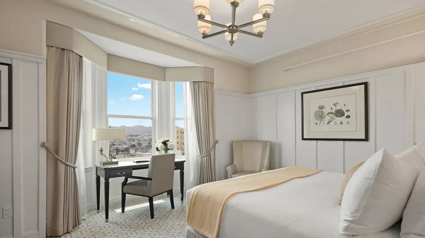 Hotel Drisco Pacific Heights bedroom in San Francisco with city views and elegant decor.