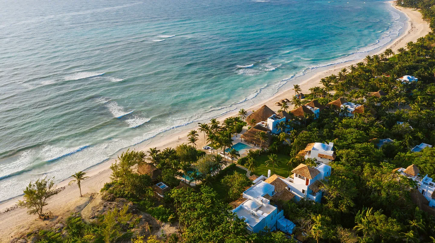 Aerial view of Hotel Esencia in Playa del Carmen, nestled on a pristine beach.