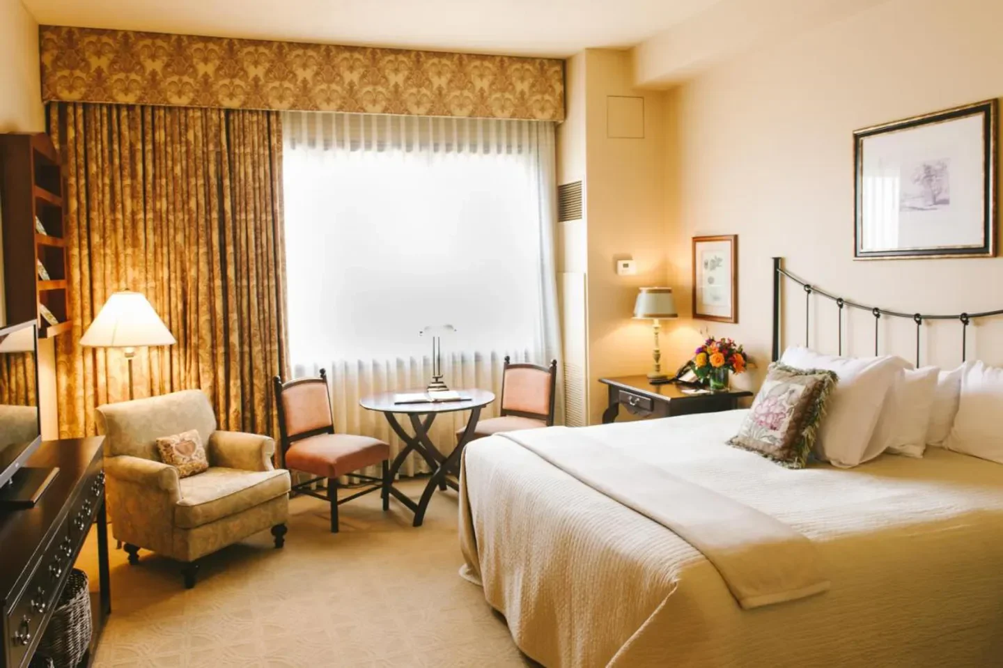 Elegant hotel room at Hotel Granduca Houston, Houston, featuring cozy seating and bed.