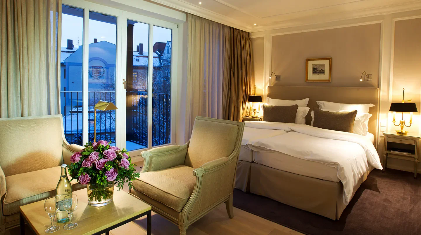 Cozy hotel room at Hotel München Palace in Munich, with a balcony view.