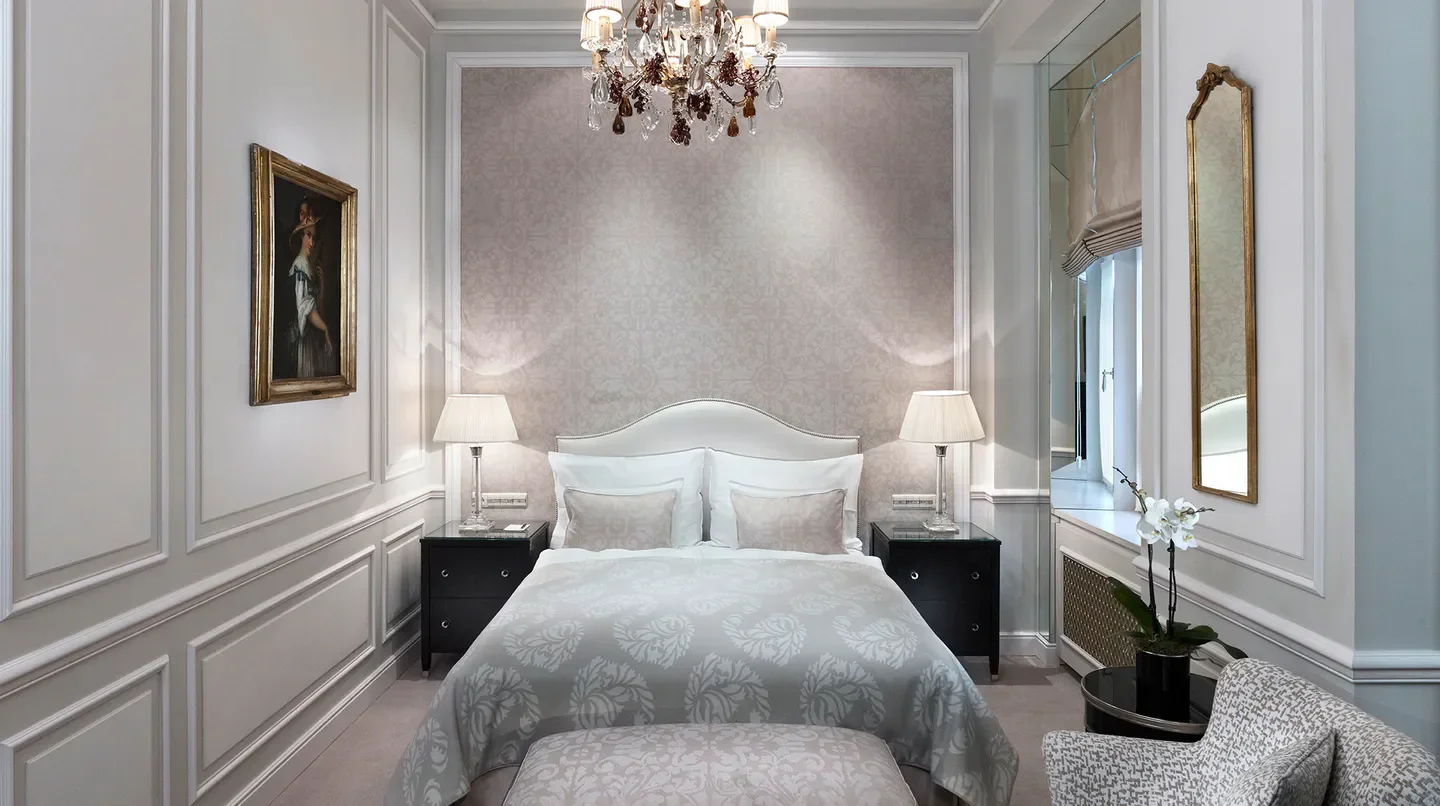 Elegant bedroom at Hotel Sacher Wien in Vienna, with chandelier and fine decor.
