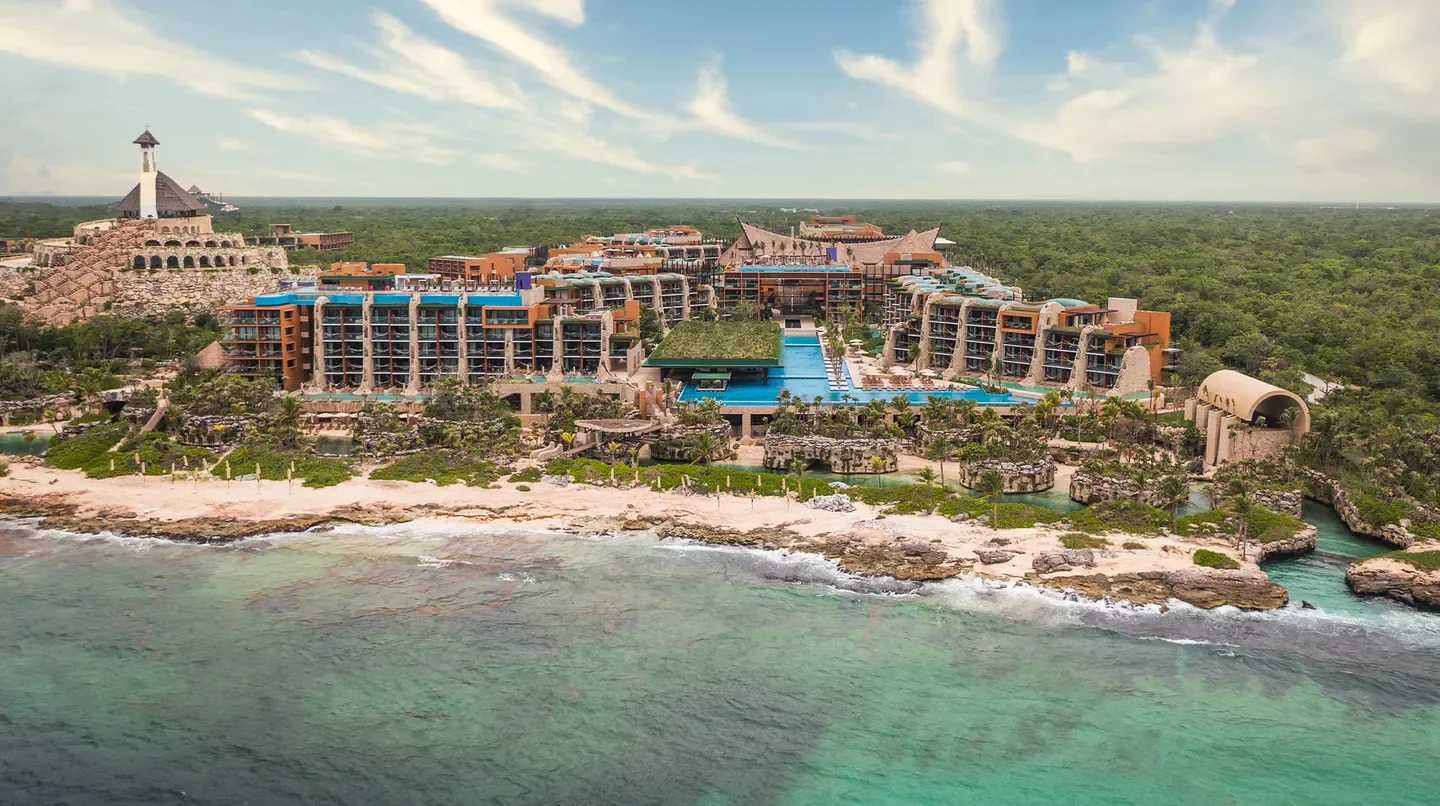 Aerial view of Hotel Xcaret Arte in Playa del Carmen, showcasing beach and architecture.