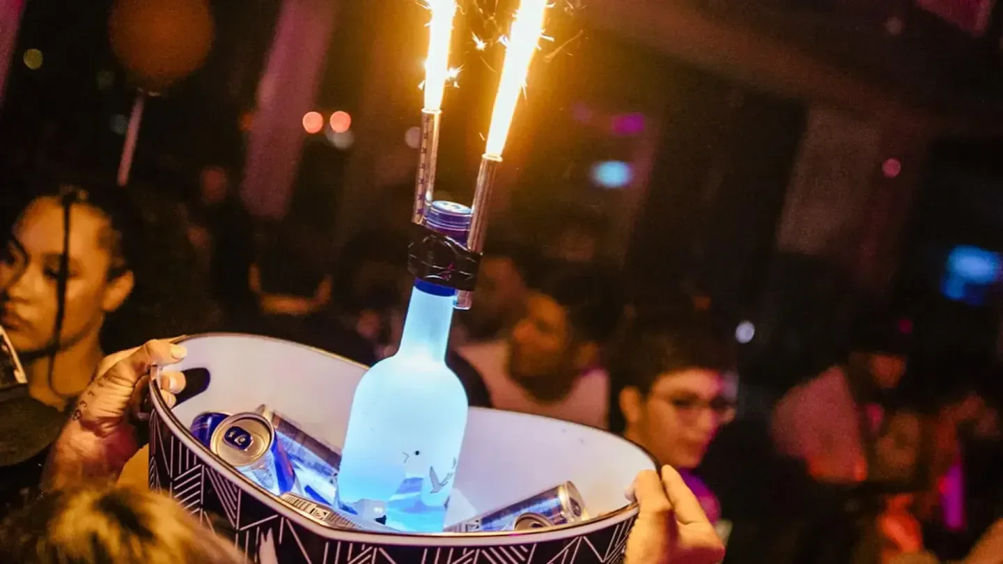 Bottle service with sparklers at House of Weekend nightclub in Berlin, festive vibes.