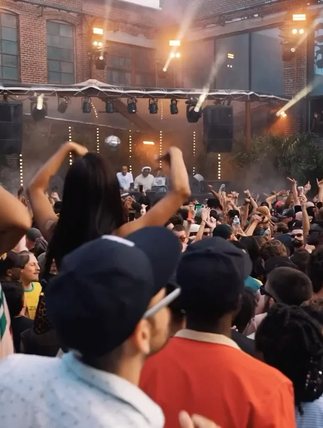Energetic crowd dancing at House of Yes nightclub in the city under bright stage lights