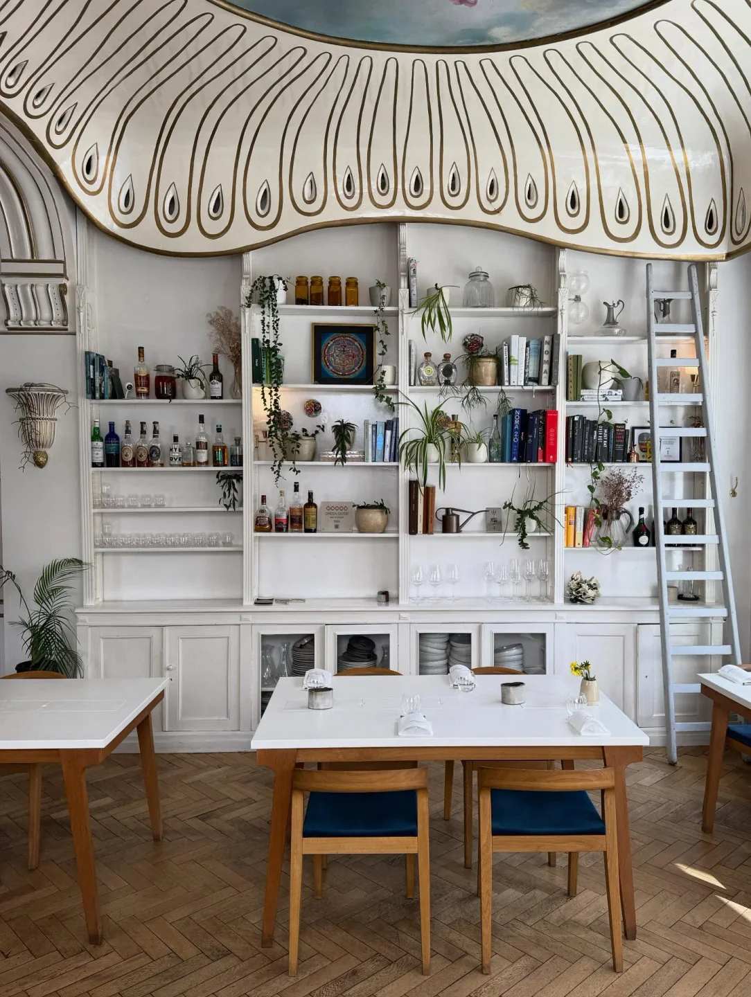 Interior of Humus x Hortense restaurant in Brussels, Belgium, featuring elegant decor and dining tables.