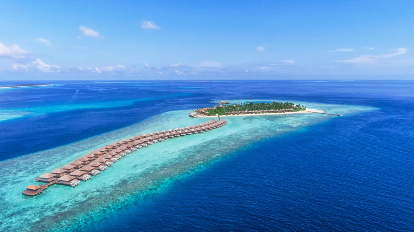 Aerial view of Hurawalhi Island Resort in the Maldives, overwater bungalows and turquoise waters