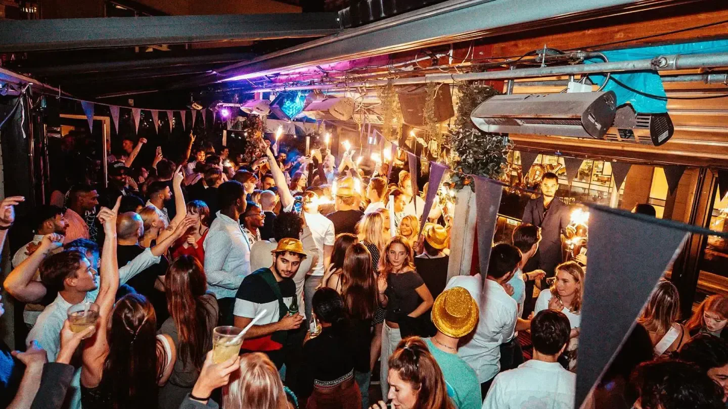 Energetic crowd at Hyde nightclub in Stockholm enjoying a lively night out with sparklers.