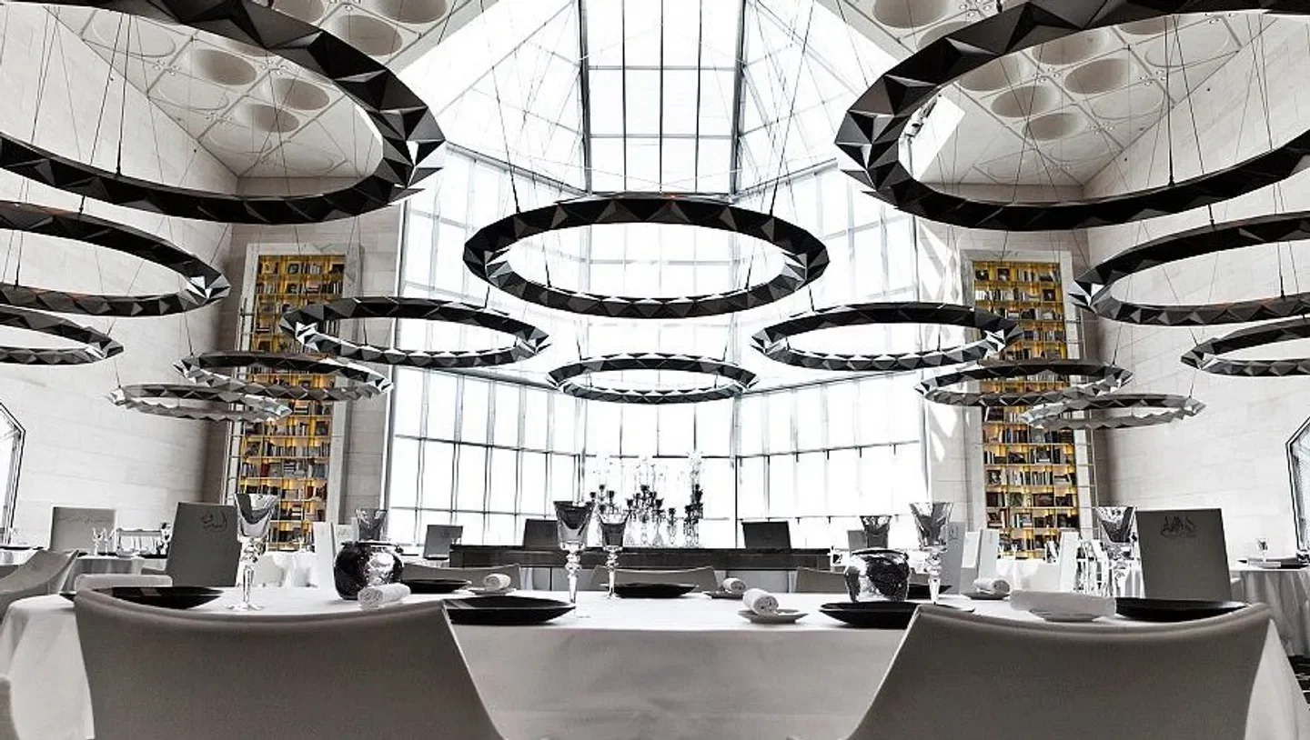 Idam By Alain, Doha: modern restaurant interior with geometric lighting and tables