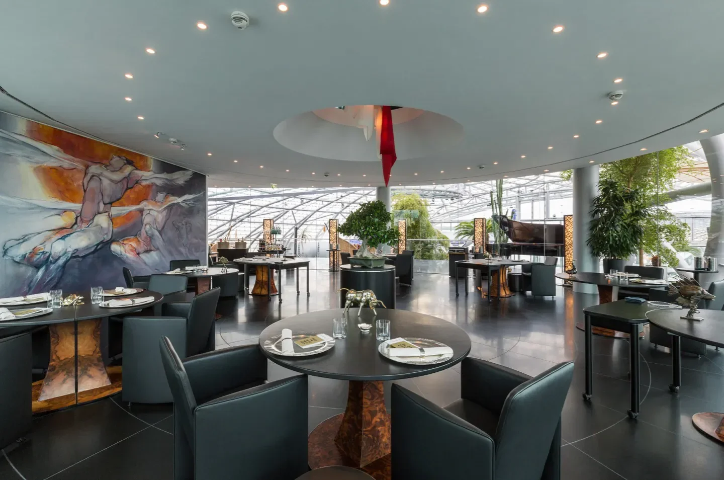 Interior dining space at Ikarus restaurant in Salzburg, with stylish decor and artwork.