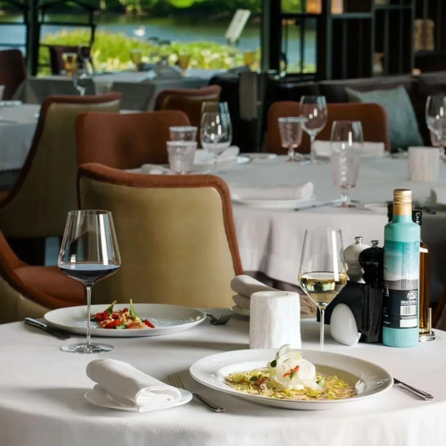 Elegant dining at Il Lago dei Cigni restaurant in St Petersburg, with lake view.