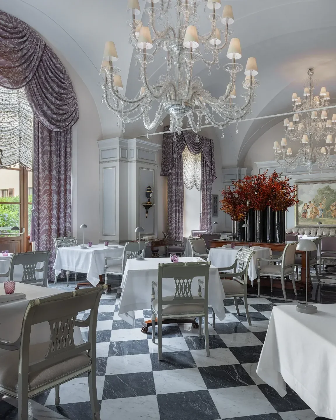 Elegant dining room at Il Palagio in Florence with chandeliers and checkered floors