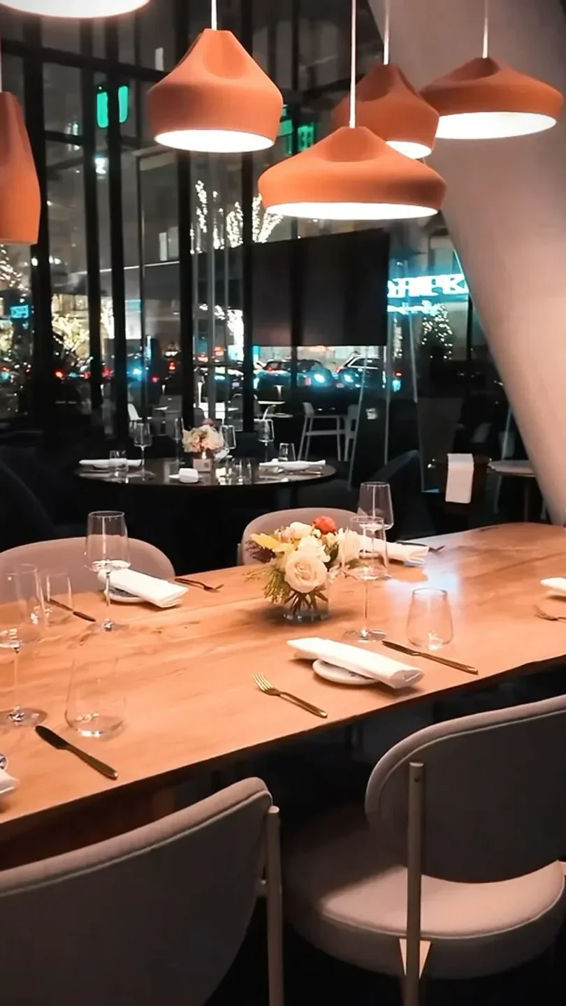 Cozy dining area at Imperfecto: The Chef's Table in Washington, featuring floral centerpieces.