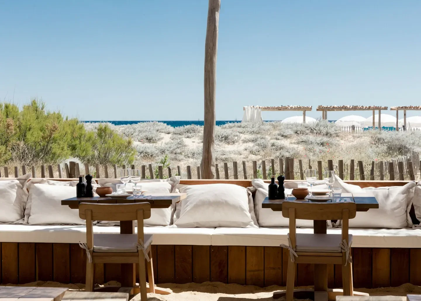Indie Beach in Saint-Tropez: beach club seating with ocean view and sandy ground