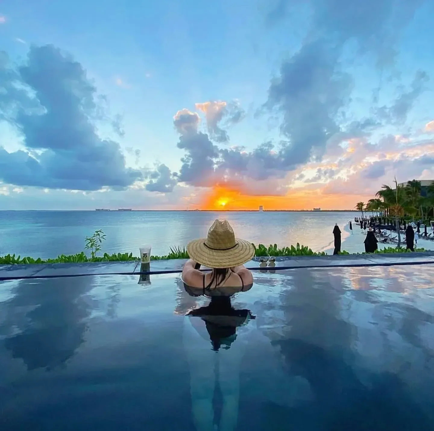 Indochine Cancun restaurant view: relaxing in the pool, enjoying the sunset over the sea