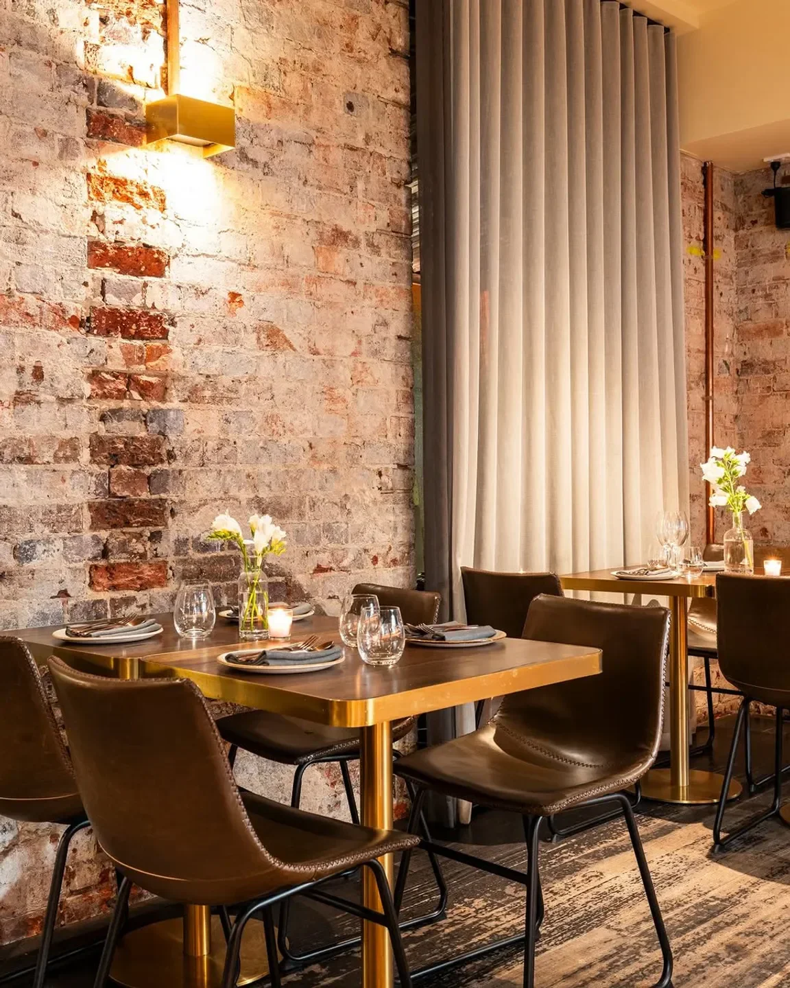 Cozy dining area at INDU Dining - Melbourne with brick walls and leather chairs in Melbourne.