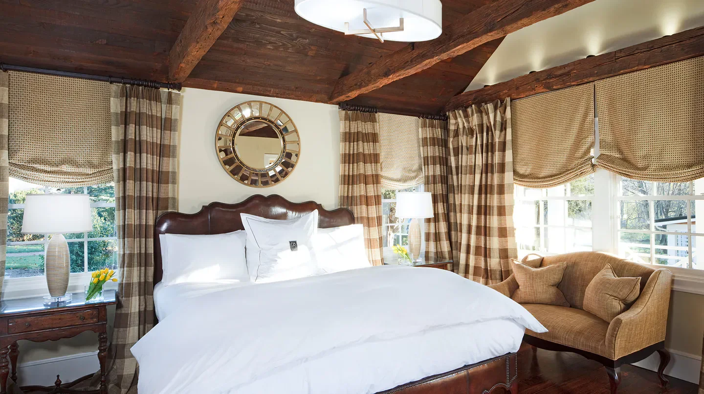 Cozy bedroom at the Inn at Willow Grove, a luxurious hotel in Charlottesville.
