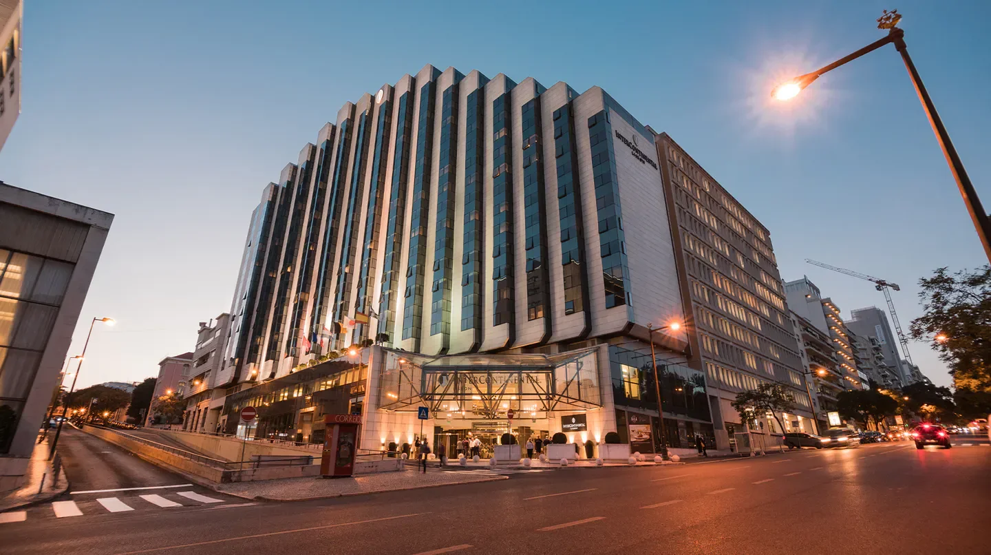 Exterior view of InterContinental Lisbon hotel in the city of Lisbon at dusk.