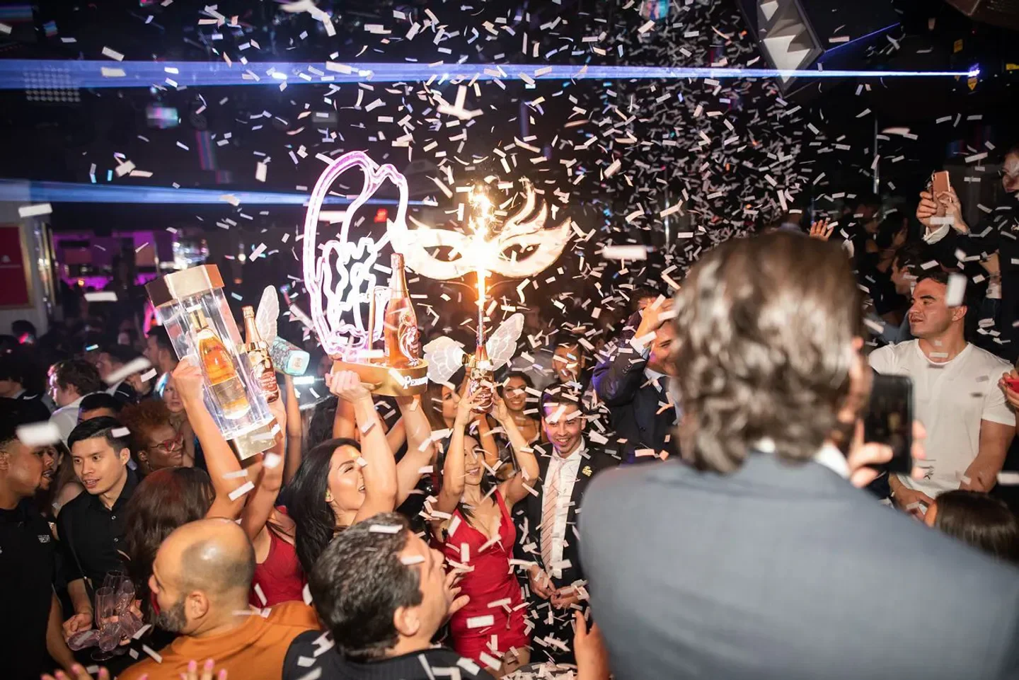 Confetti celebration at Intrigue nightclub in Las Vegas with bottle service and a lively crowd.