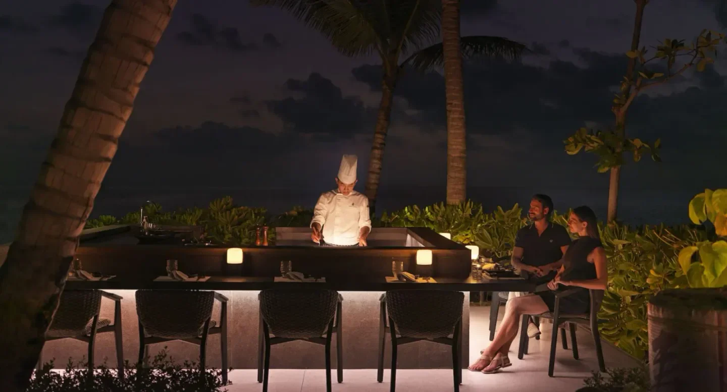 Chef preparing teppanyaki at Iwau at The Ritz-Carlton Maldives, romantic dinner setting