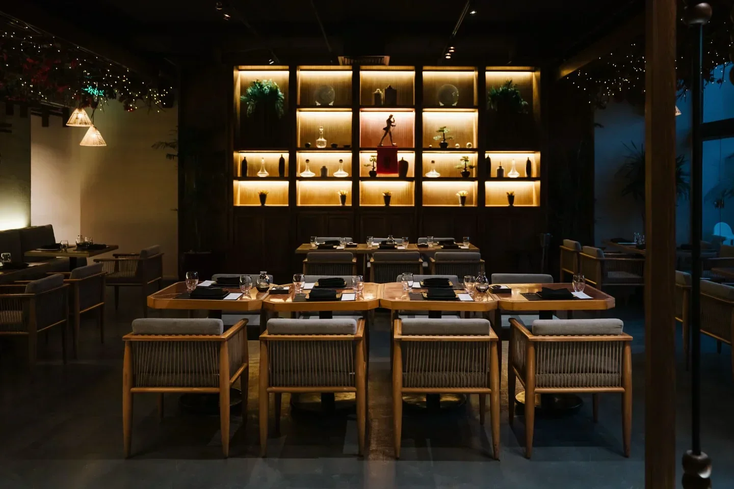 Cozy dining area at Izakaya Cairo with stylish wooden tables and chairs.