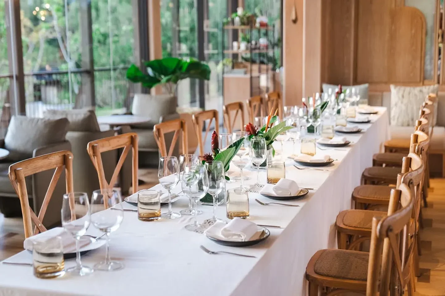 Elegant dining setup at Jampa restaurant in Phuket, Thailand, with a long table setting.