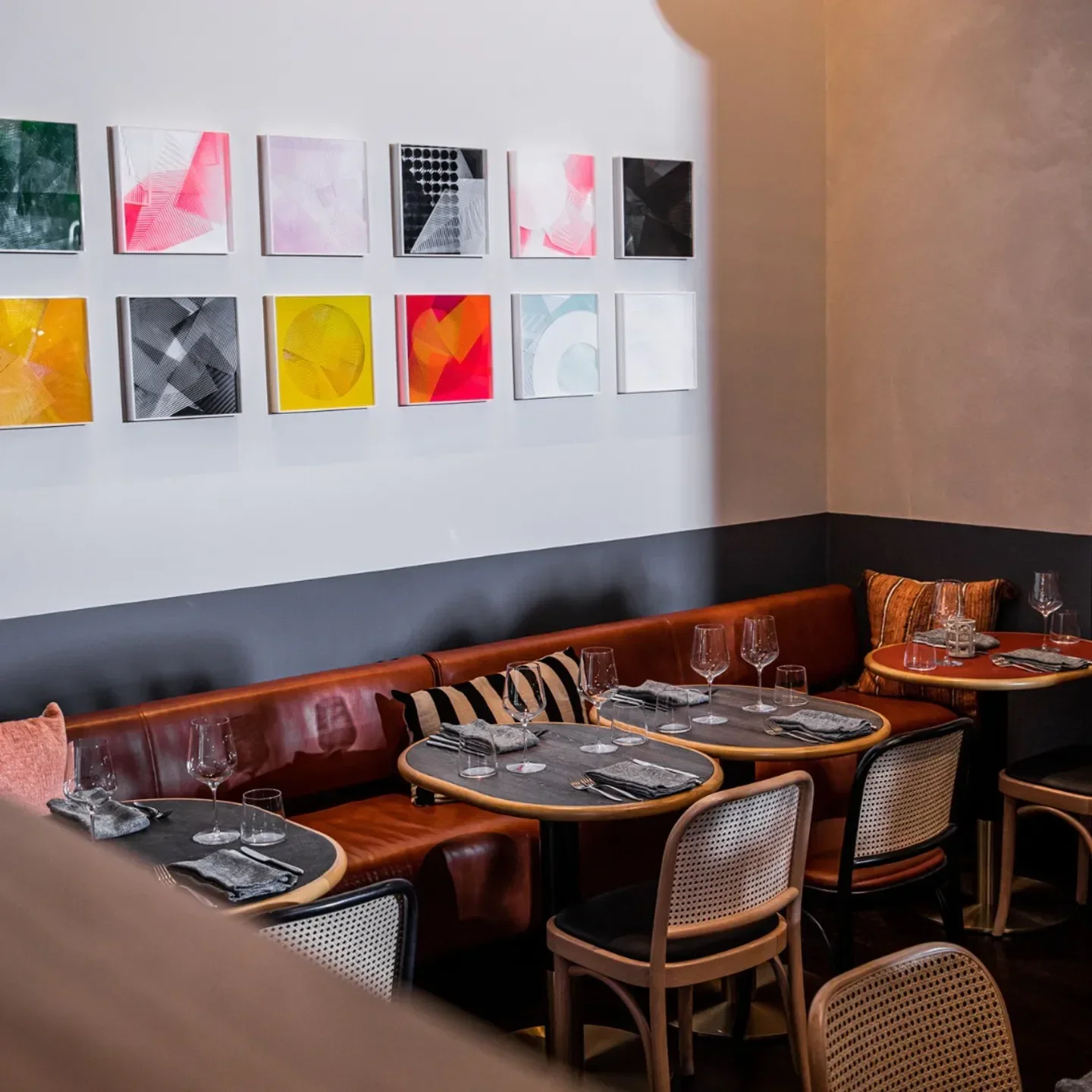 Cozy dining area at Jana Restaurant & Bar in Newcastle, featuring art and seating.