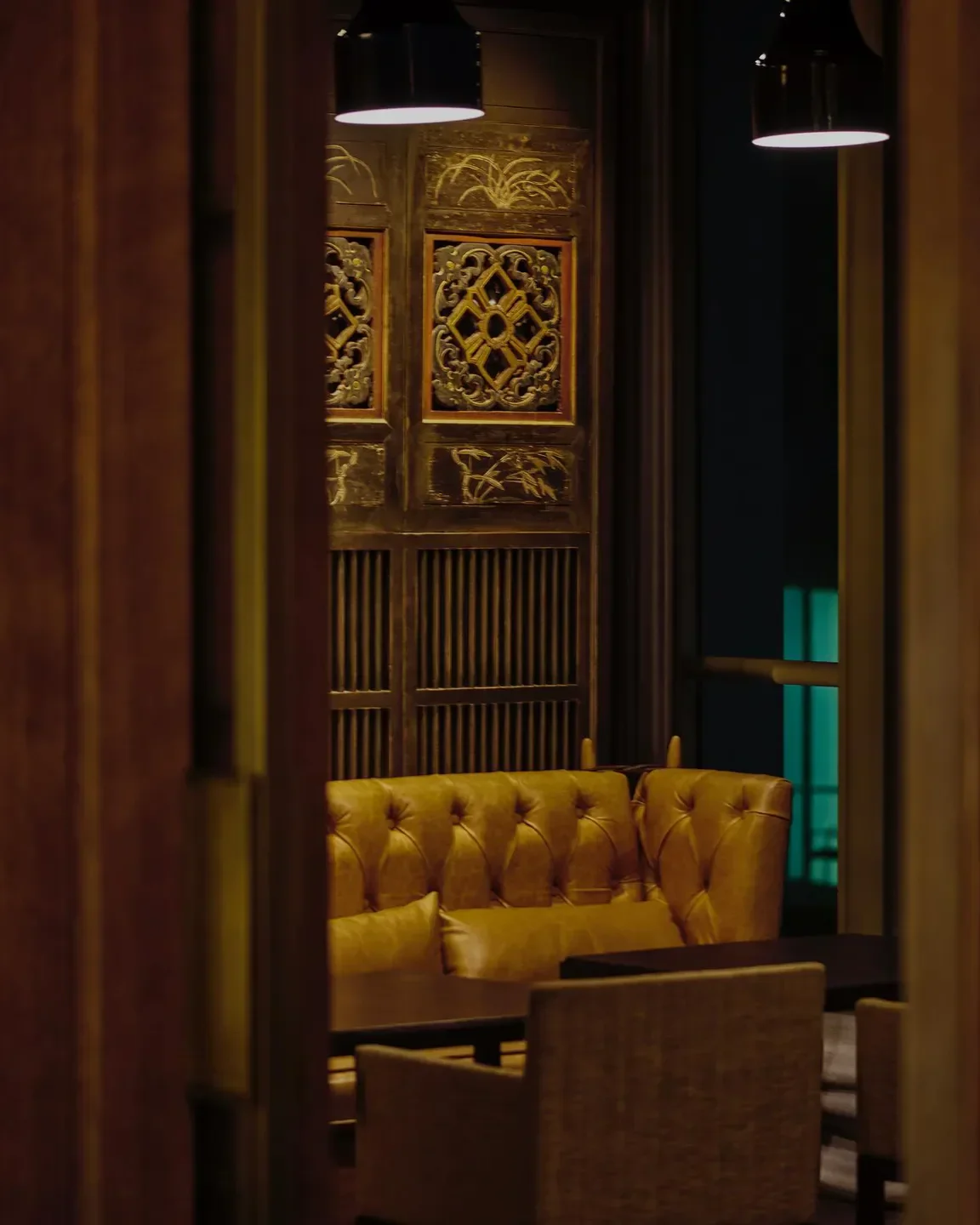 Elegant seating inside Jiang by Chef Fei in Guangzhou, featuring traditional Chinese decor