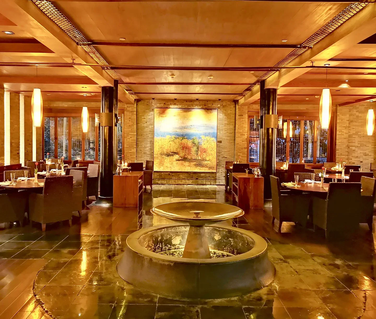 Elegant interior of Jie Xiang Lou restaurant in Hangzhou, featuring water feature and warm lighting