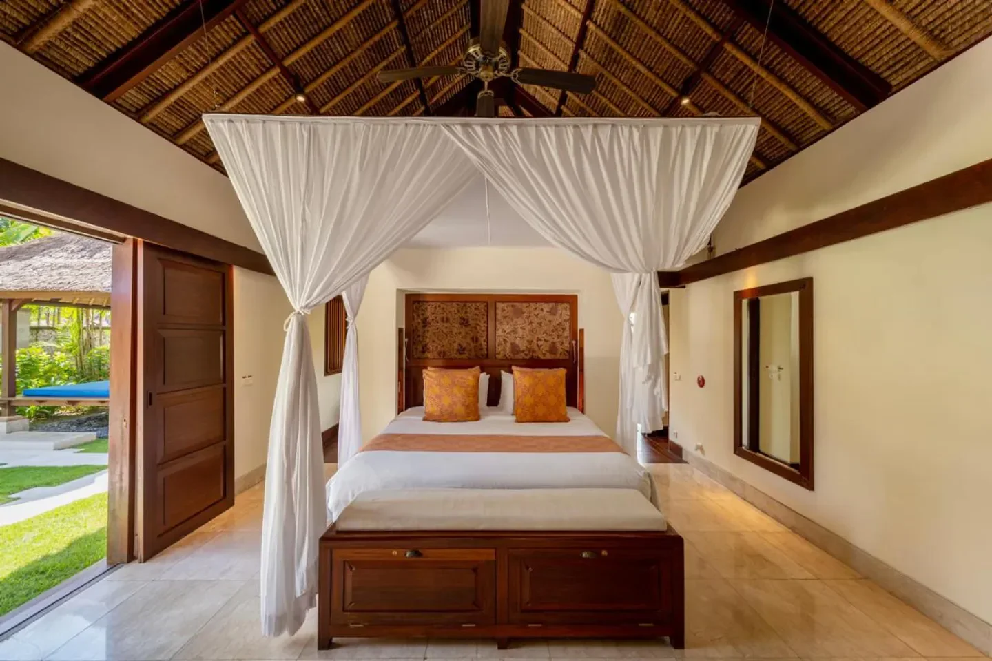 Elegant bedroom at Jimbaran Puri, A Belmond Hotel, Bali, featuring a canopy bed.