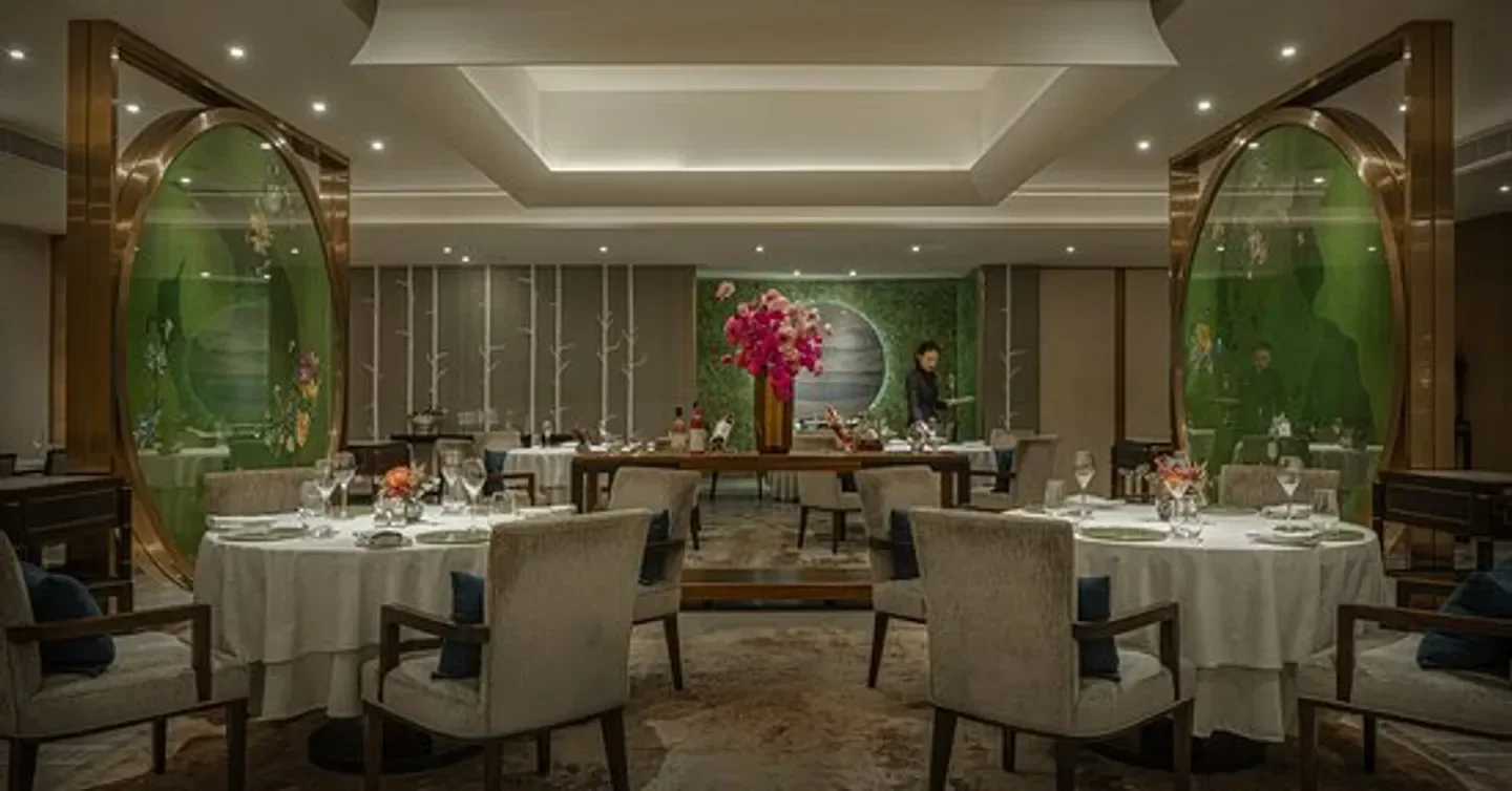 Elegant dining room at Jing restaurant in Beijing, featuring stylish decor and tables.