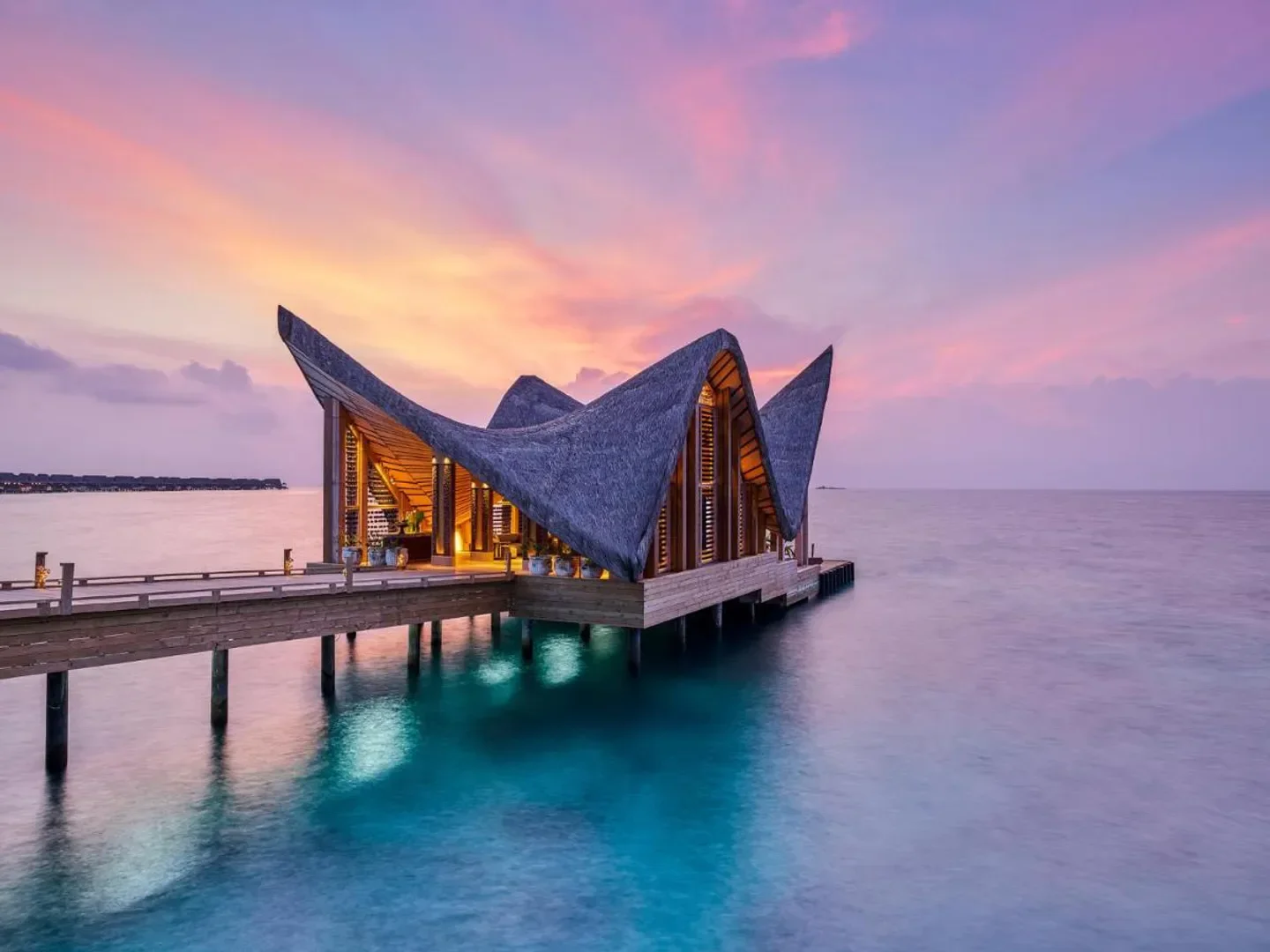 Stunning sunset over water villa at JOALI BEING in the Maldives, overwater restaurant.