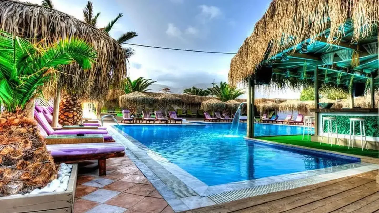 Jojo Beach Club in Santorini with pool, cabanas, and lounge chairs for a relaxing time.
