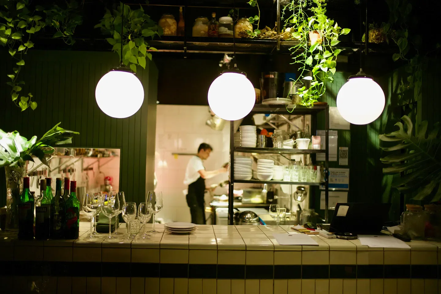 Interior of Julia restaurant in Buenos Aires: bar, glowing lights and chef in the background.