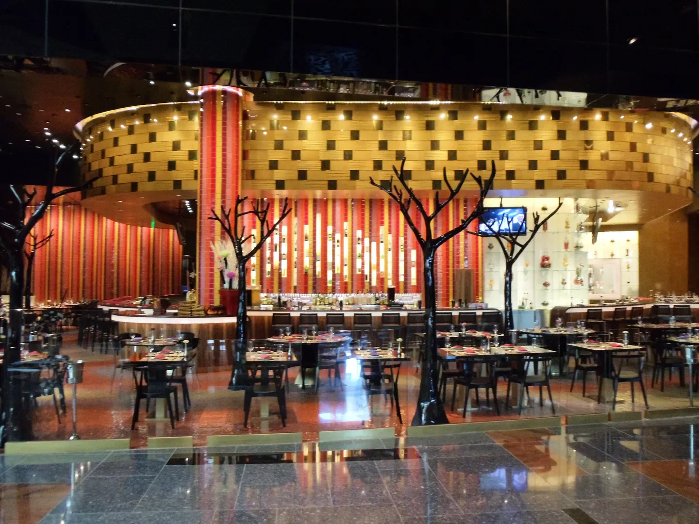 Interior of Julian Serrano Tapas restaurant in Las Vegas, with elegant tables and decor.