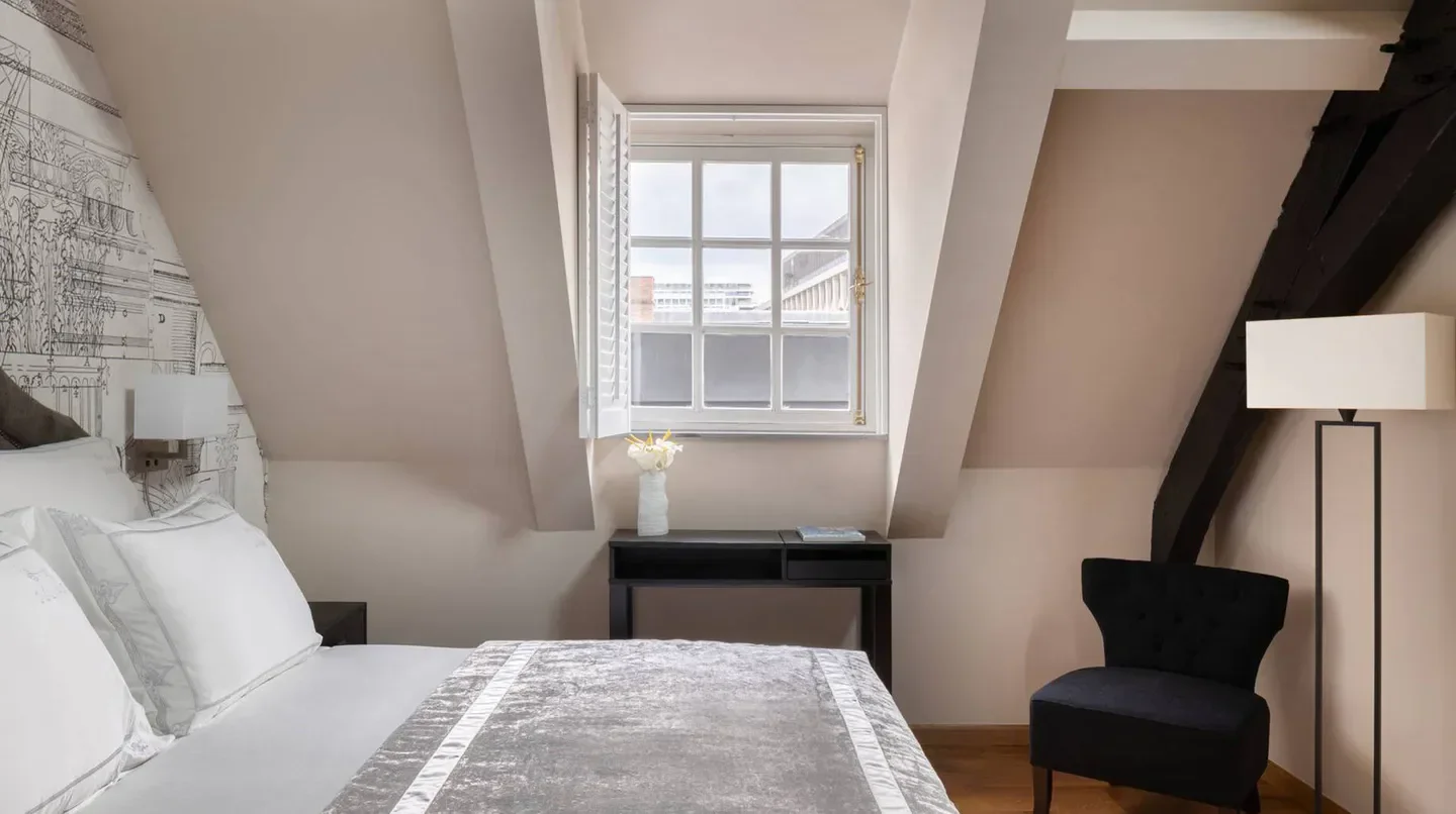 Cozy bedroom at Juliana Hotel Brussels, featuring window views in Brussels, Belgium.