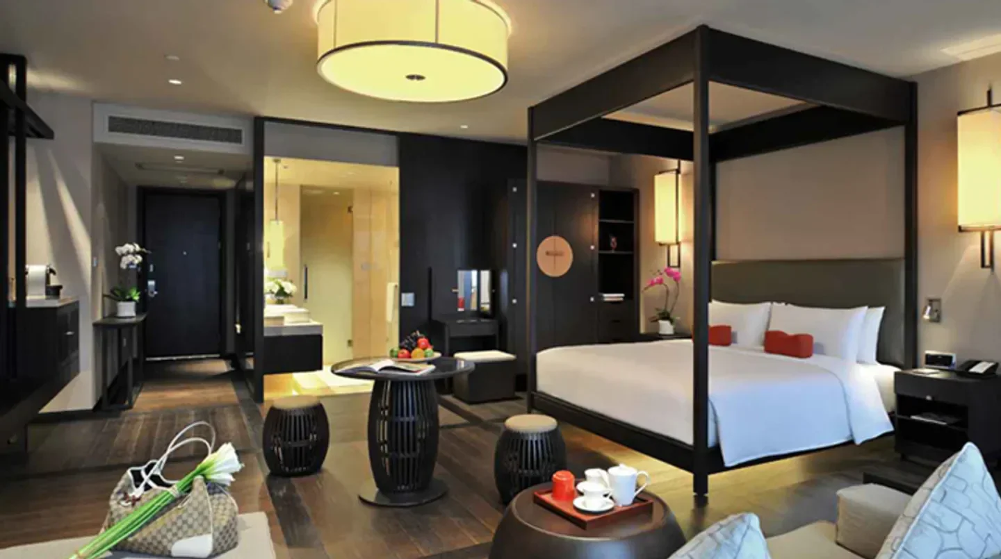 Luxury hotel room at Jumeirah Himalayas Hotel in Shanghai, featuring a canopy bed.
