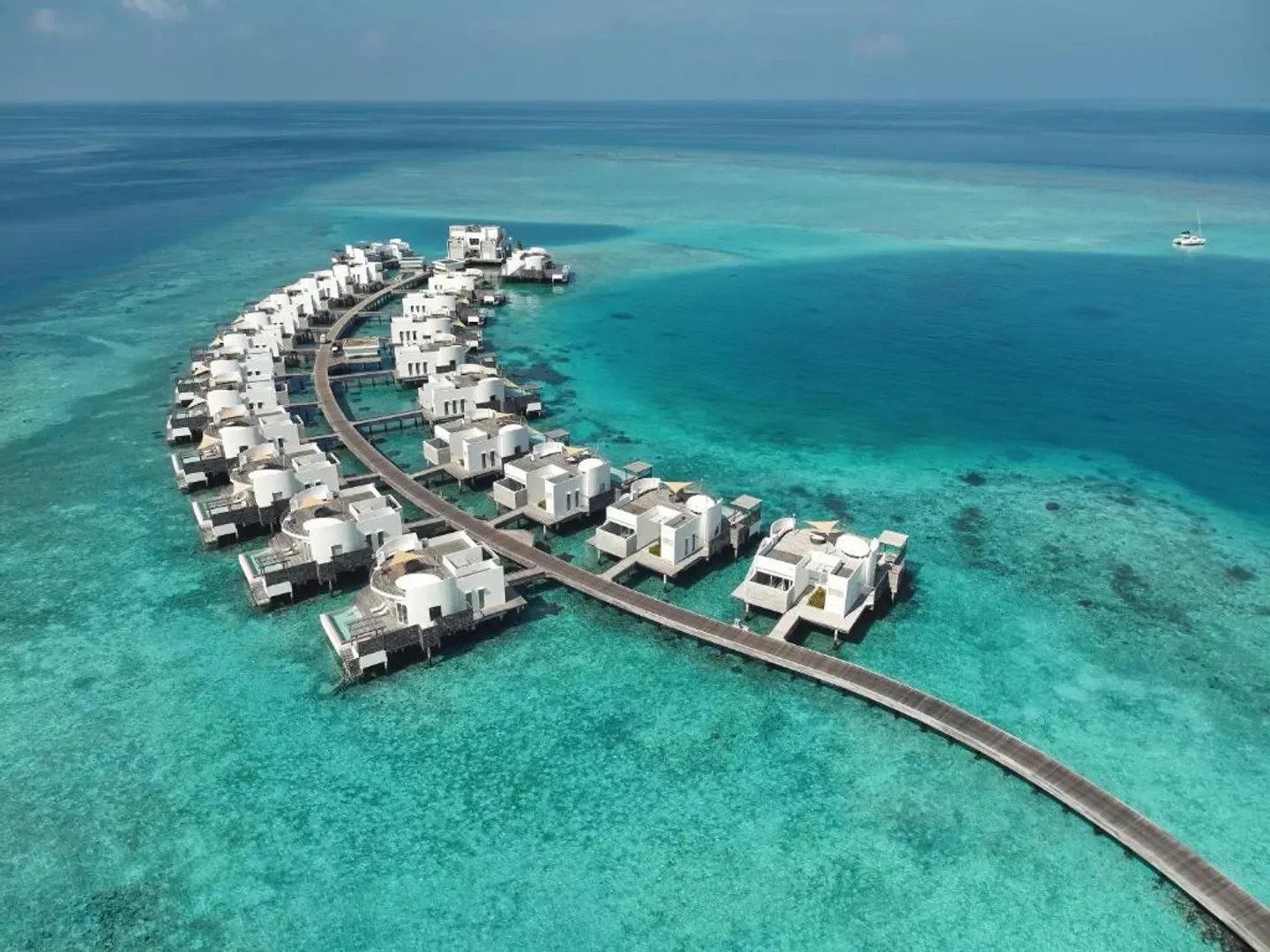 Aerial view of Jumeirah Maldives Olhahali Island's overwater villas in the Maldives.