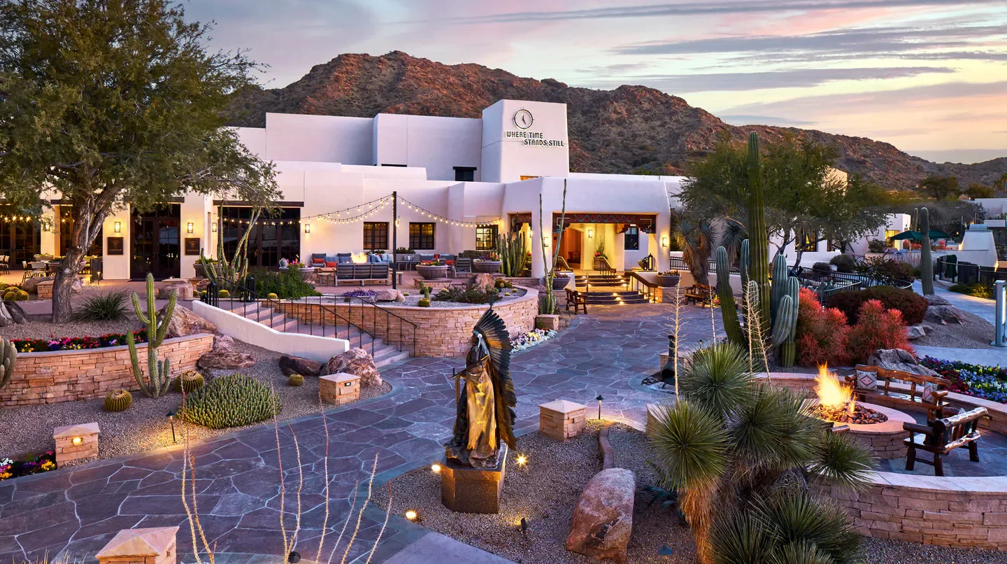 JW Marriott Scottsdale Camelback Inn Resort & Spa in Scottsdale at dusk with desert landscaping.