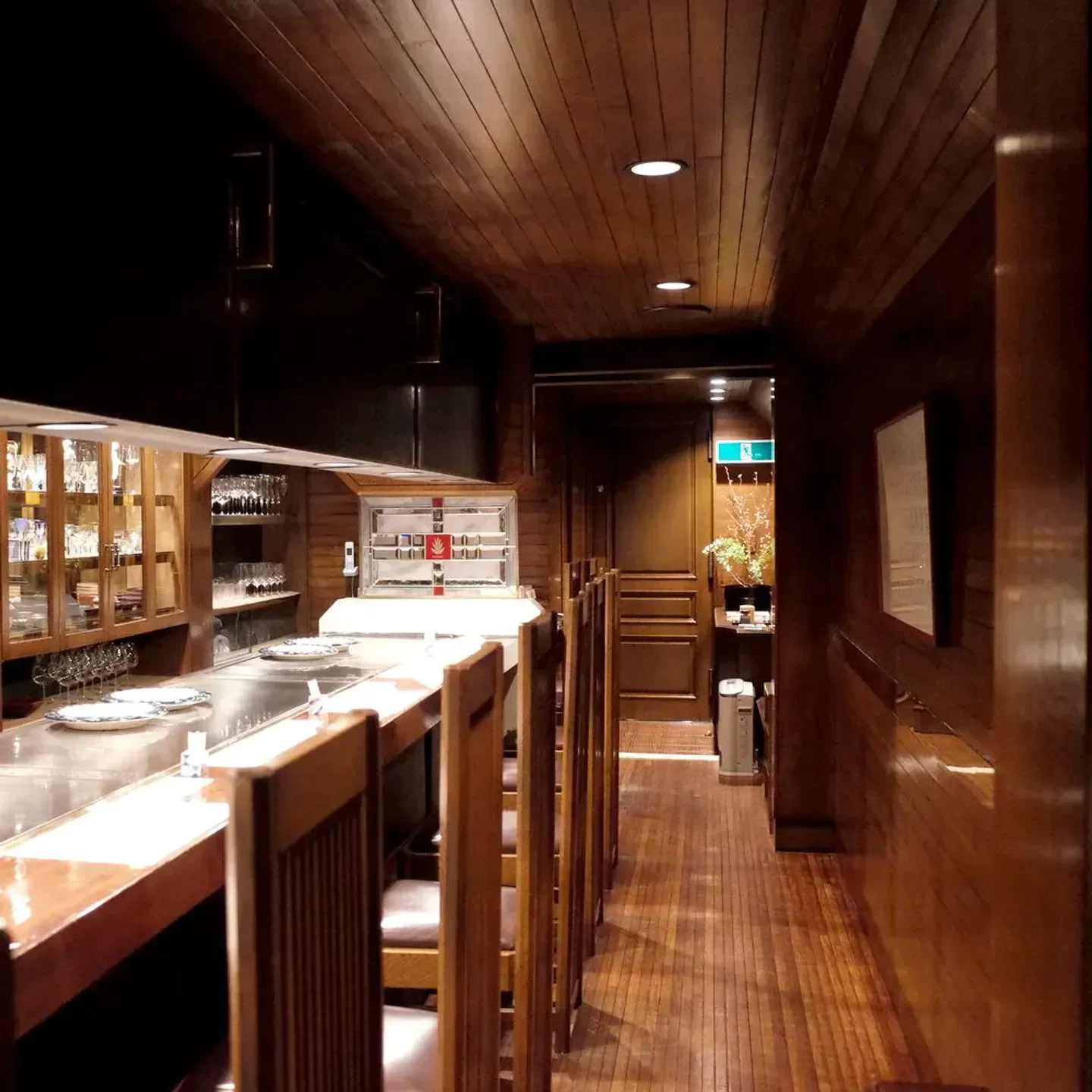 Interior of Kahala restaurant in Osaka, showcasing wooden decor and seating area.