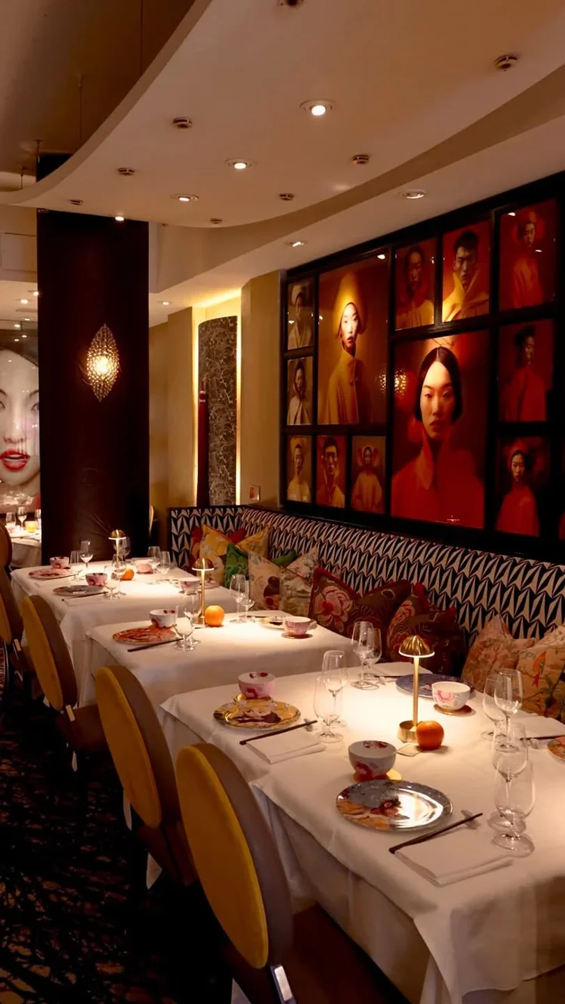 Kai restaurant in London features elegant dining tables adorned with artwork and ambient lighting.