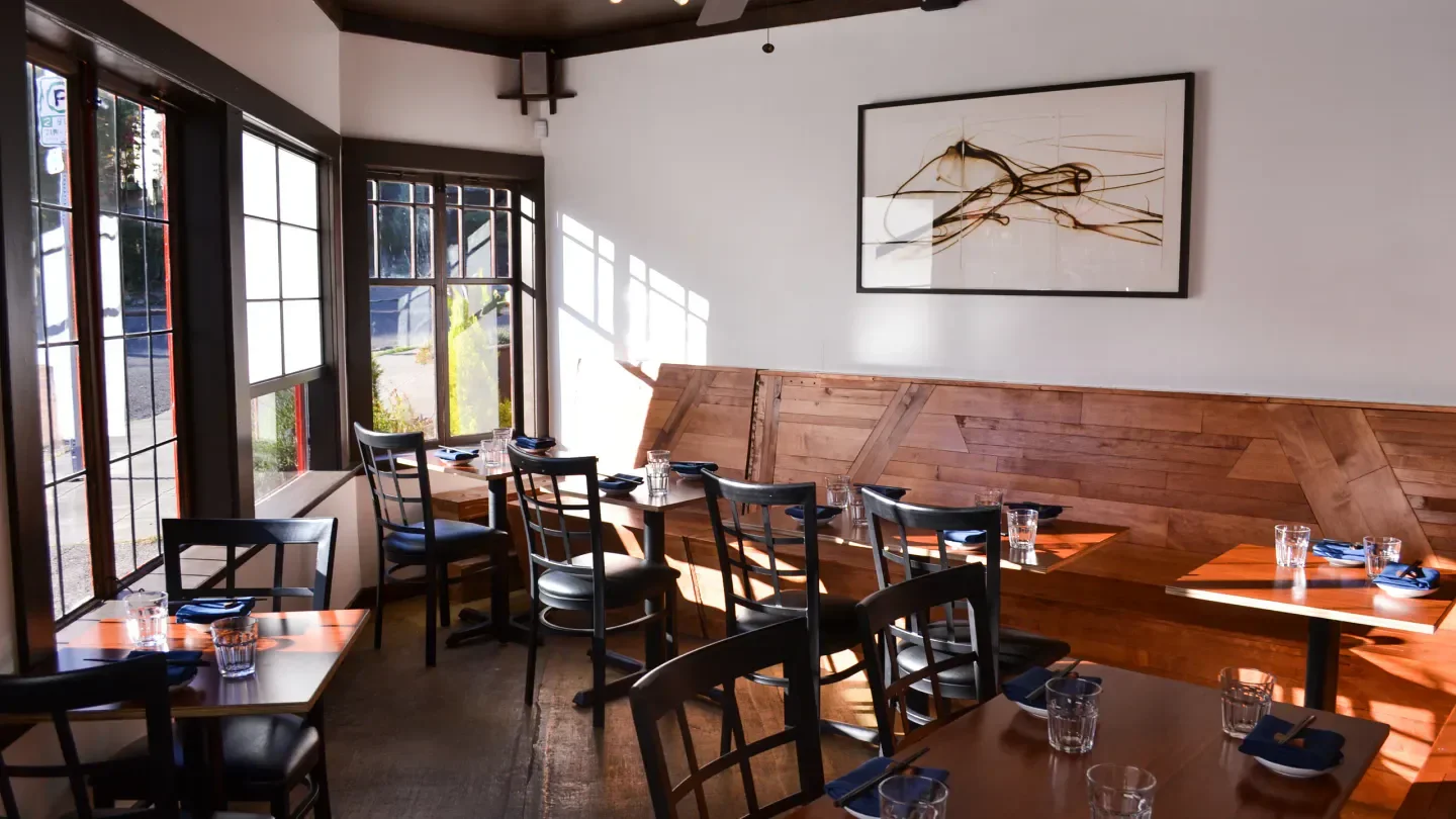 Interior dining space at Kamonegi restaurant in Seattle with natural light and wood accents.