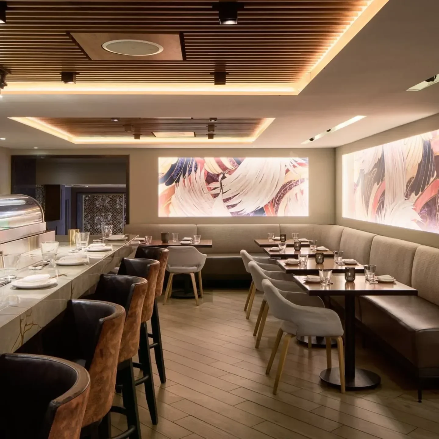 Elegant dining area at Kasa Moto restaurant in Toronto, with stylish bar seating and tables.