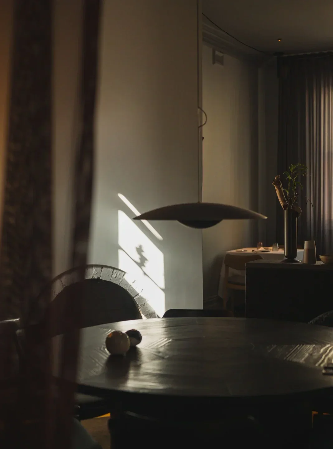 Interior of Kazuki's in Melbourne, showing soft light and a stylish, moody dining space.