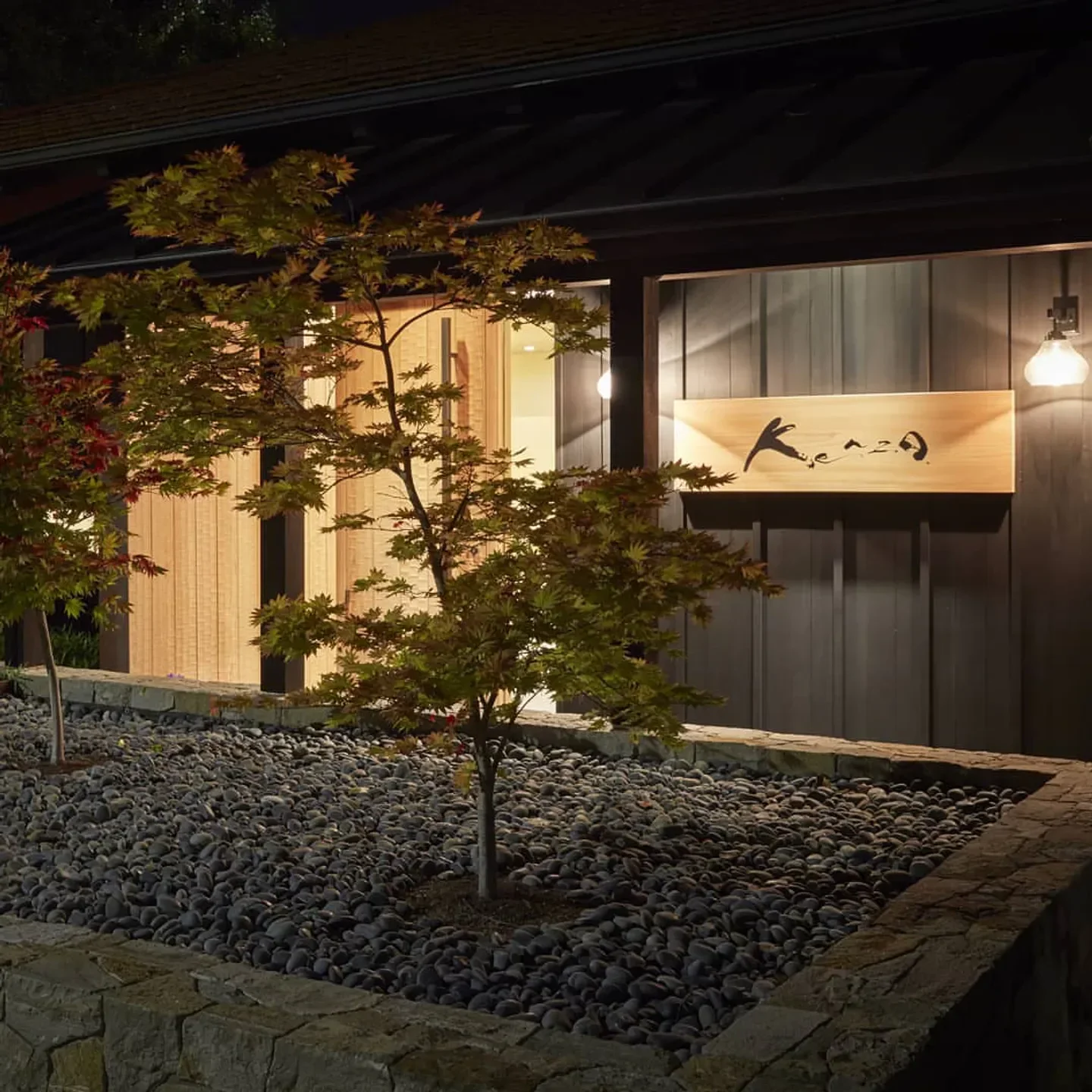 Exterior of Kenzo restaurant in Napa Valley, featuring wood sign and Japanese garden.
