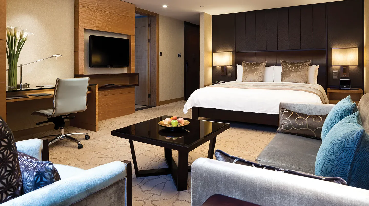 Luxury hotel room at Kerry Hotel, Pudong, Shanghai, featuring a king-size bed and desk.