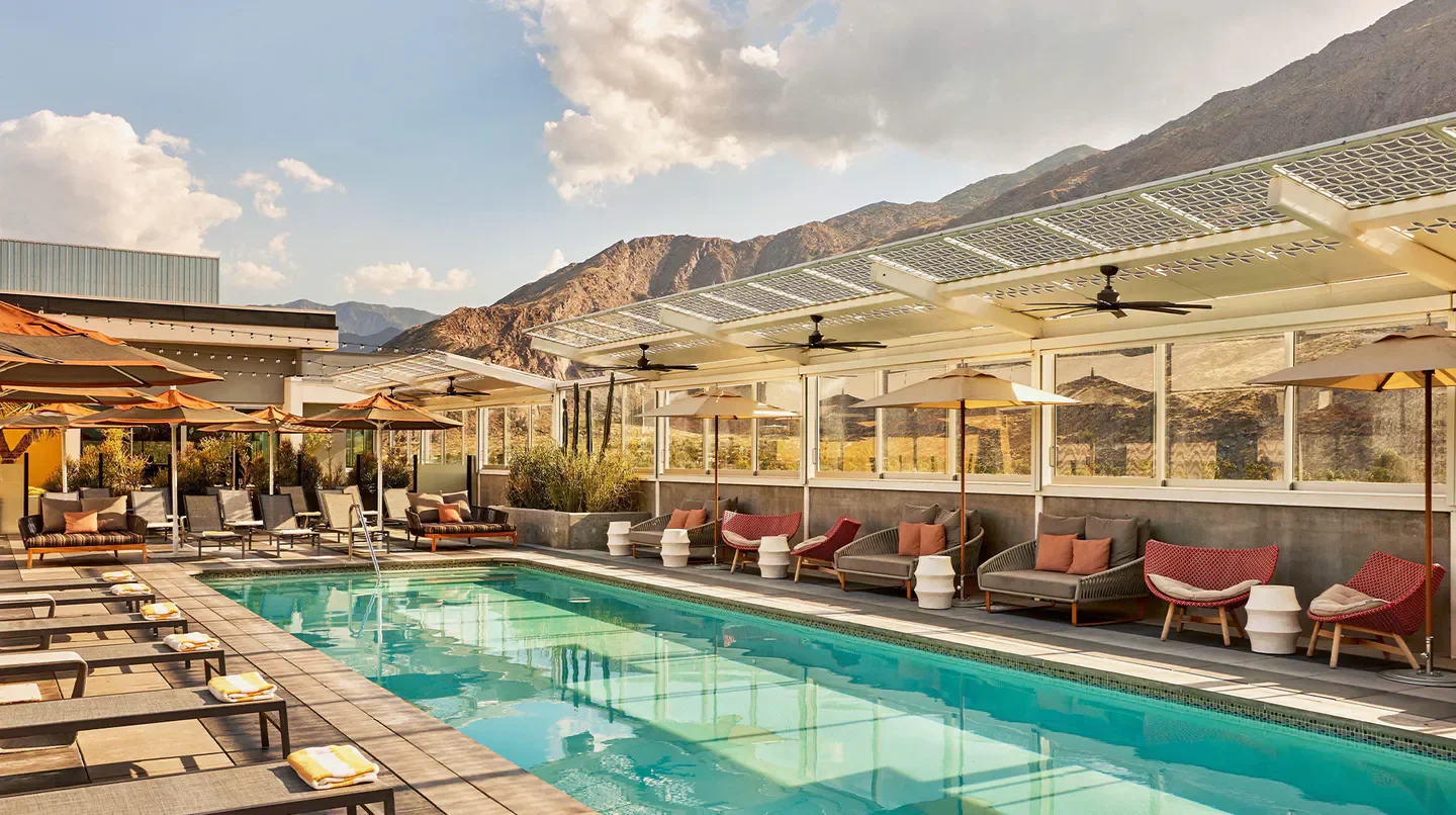 Poolside relaxation at Kimpton Rowan Palm Springs with mountain views in Palm Springs