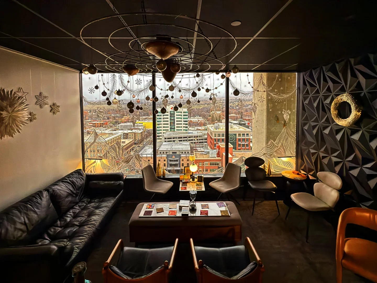 Interior of KIN restaurant in Boise with a view of the city, decorative lighting, and stylish seating.
