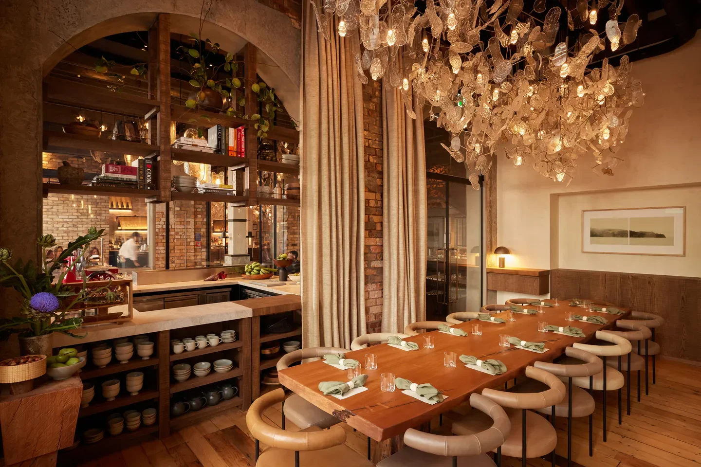 Interior of Kingi restaurant in Auckland, with a long dining table and unique chandelier