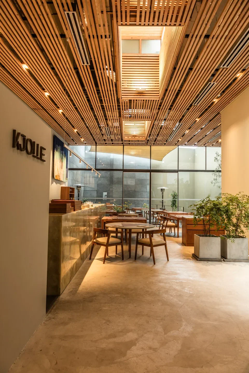 Interior of Kjolle restaurant in Lima, featuring wooden ceiling and stylish dining area.