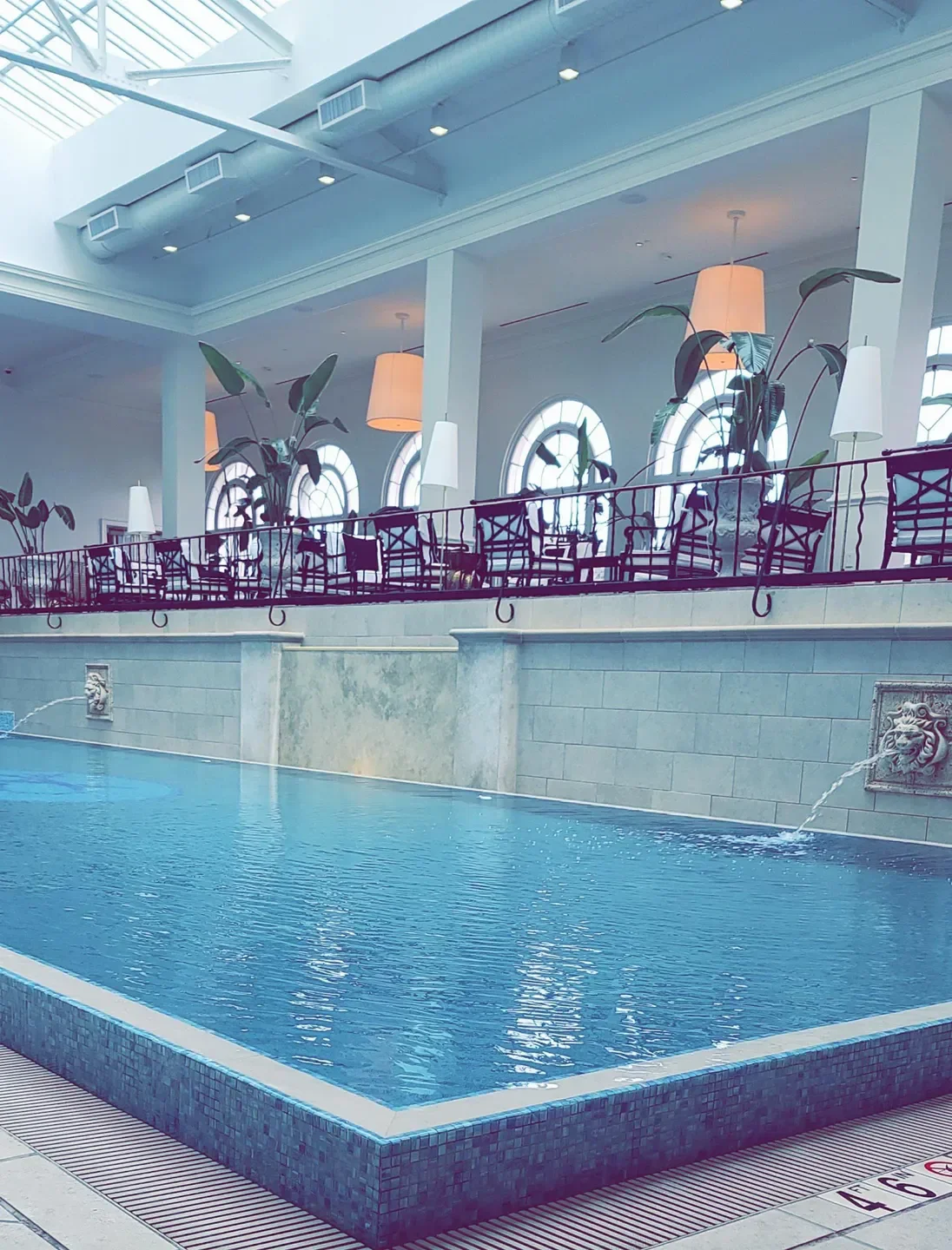 Indoor pool at Kohler Waters Spa in Virginia Beach with stylish decor and fixtures.